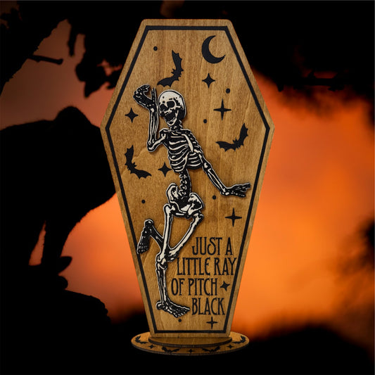 "Just A Little Ray of Pitch Black" Skeleton Coffin Sign